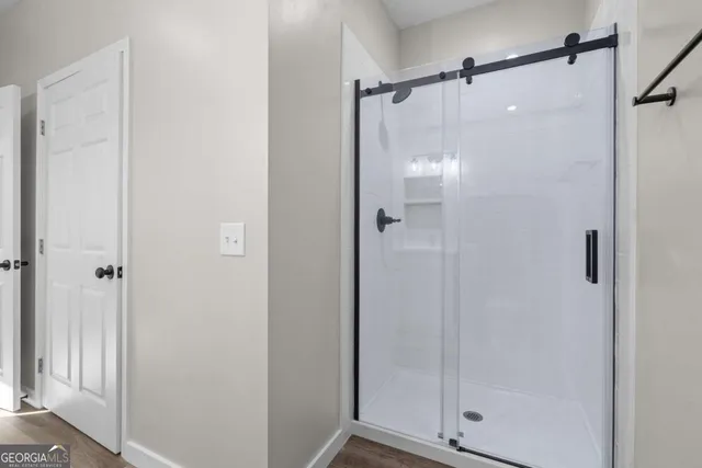 a bathroom with a glass shower door