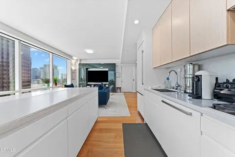 a kitchen with stainless steel appliances a stove and white cabinets