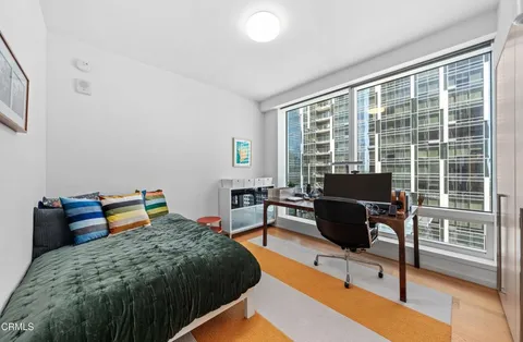 a bedroom with furniture and a window