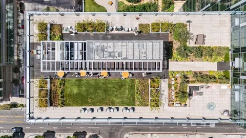 a room with stainless steel appliances kitchen island granite countertop furniture and a chandelier