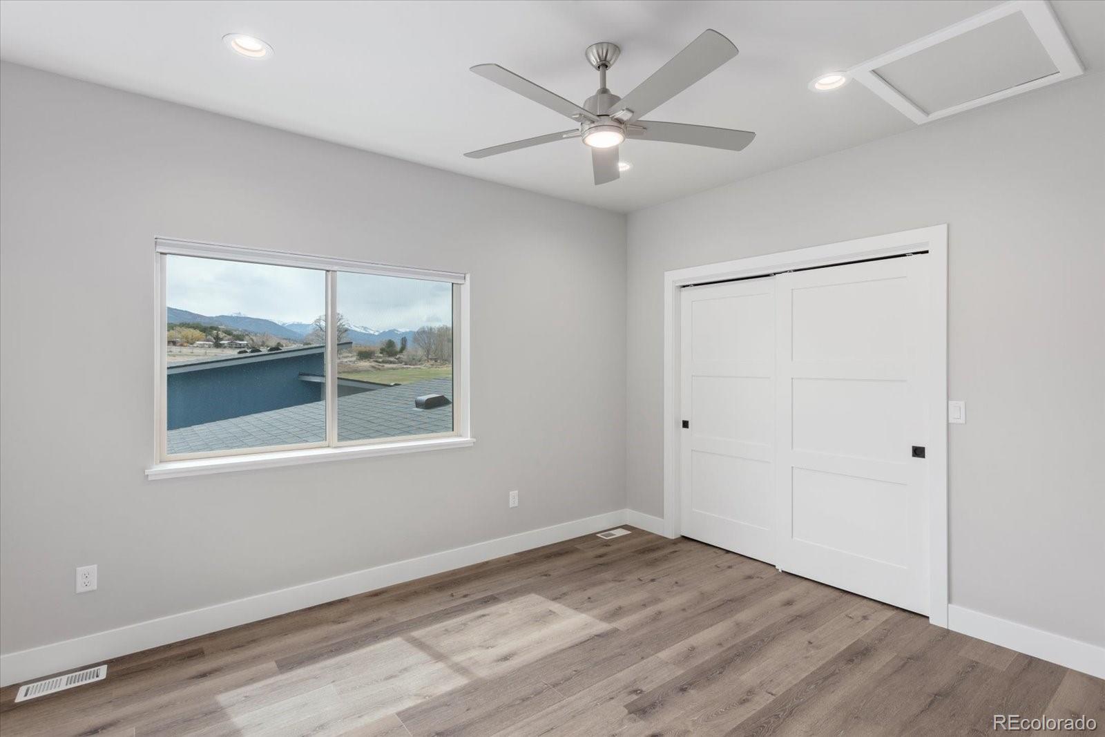 128 Southside Loop Salida, CO 81201 - Photo 16 of 20 an empty room with wooden floor and windows