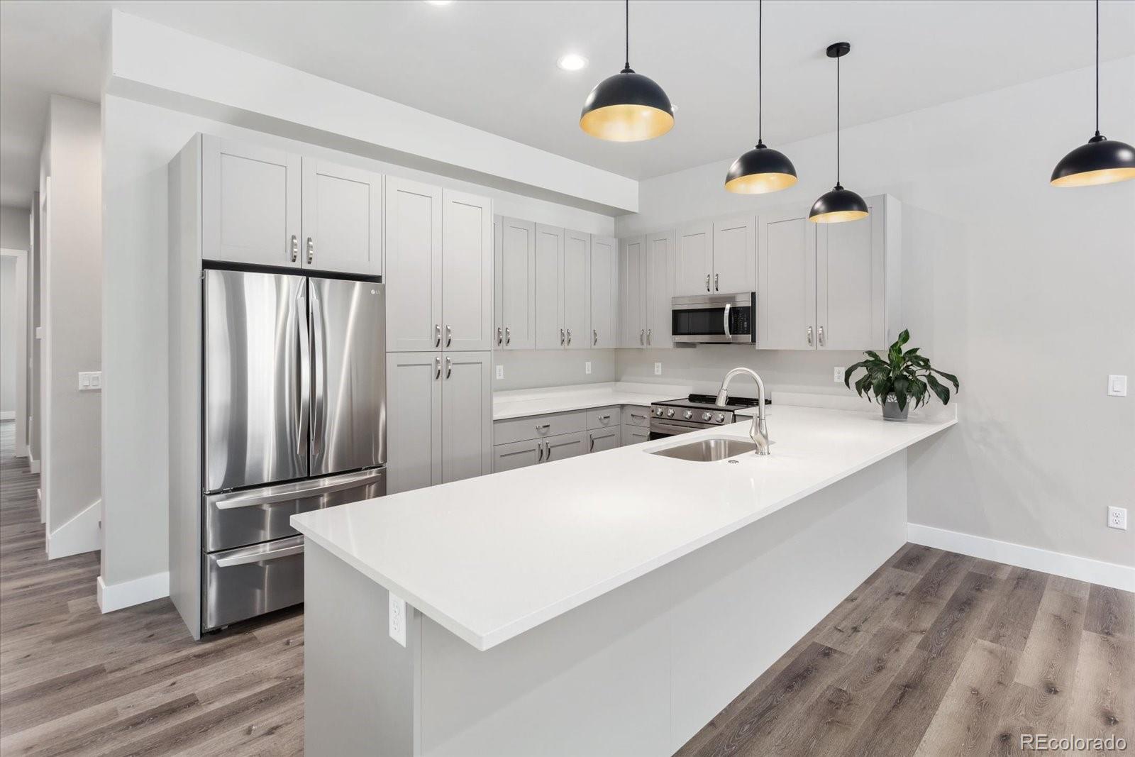 128 Southside Loop Salida, CO 81201 - Photo 4 of 20 a kitchen with kitchen island a counter space a sink appliances and cabinets