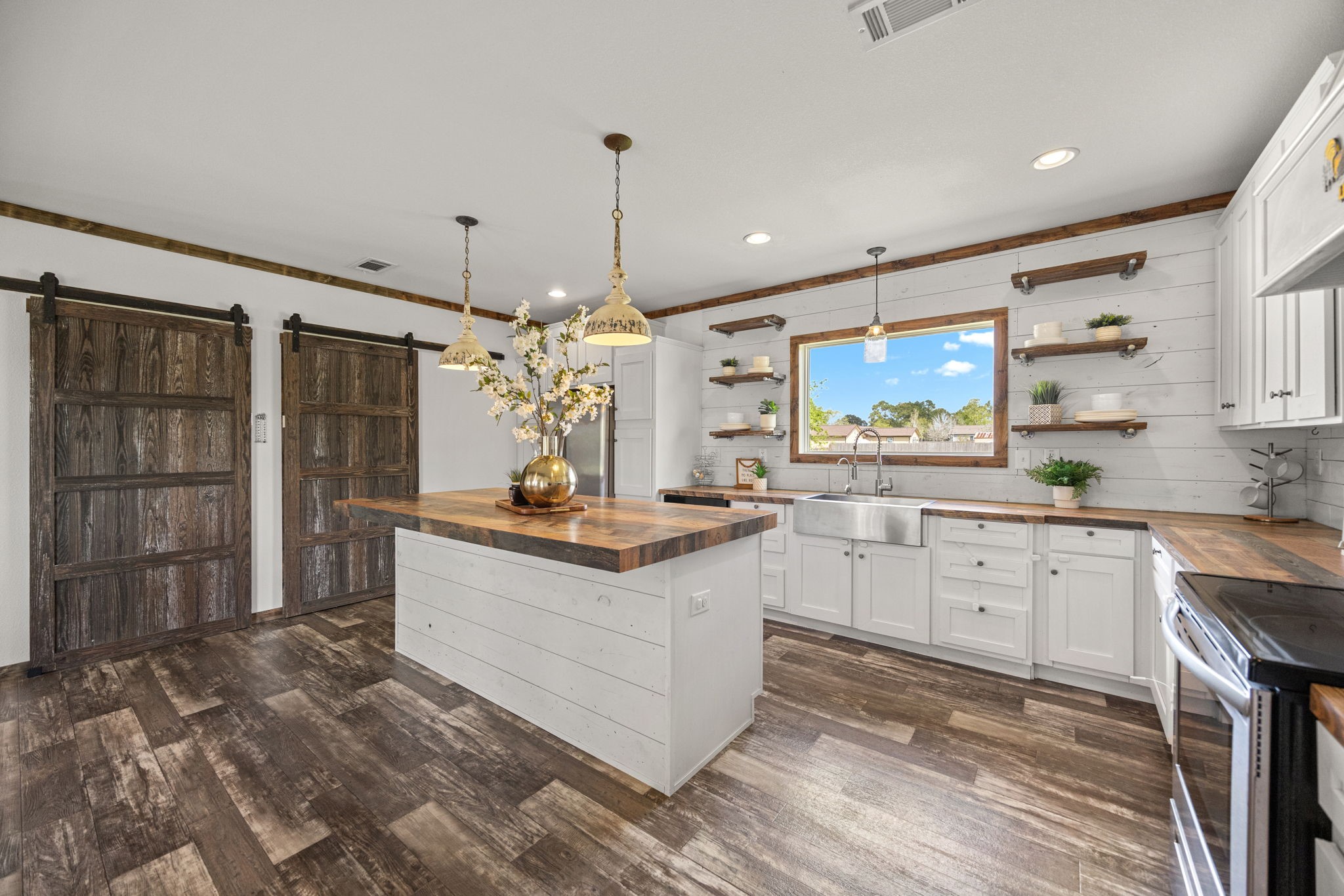 12708 28th Street Santa Fe, TX 77510 - Photo 11 of 29 a kitchen with stainless steel appliances granite countertop a sink stove and refrigerator