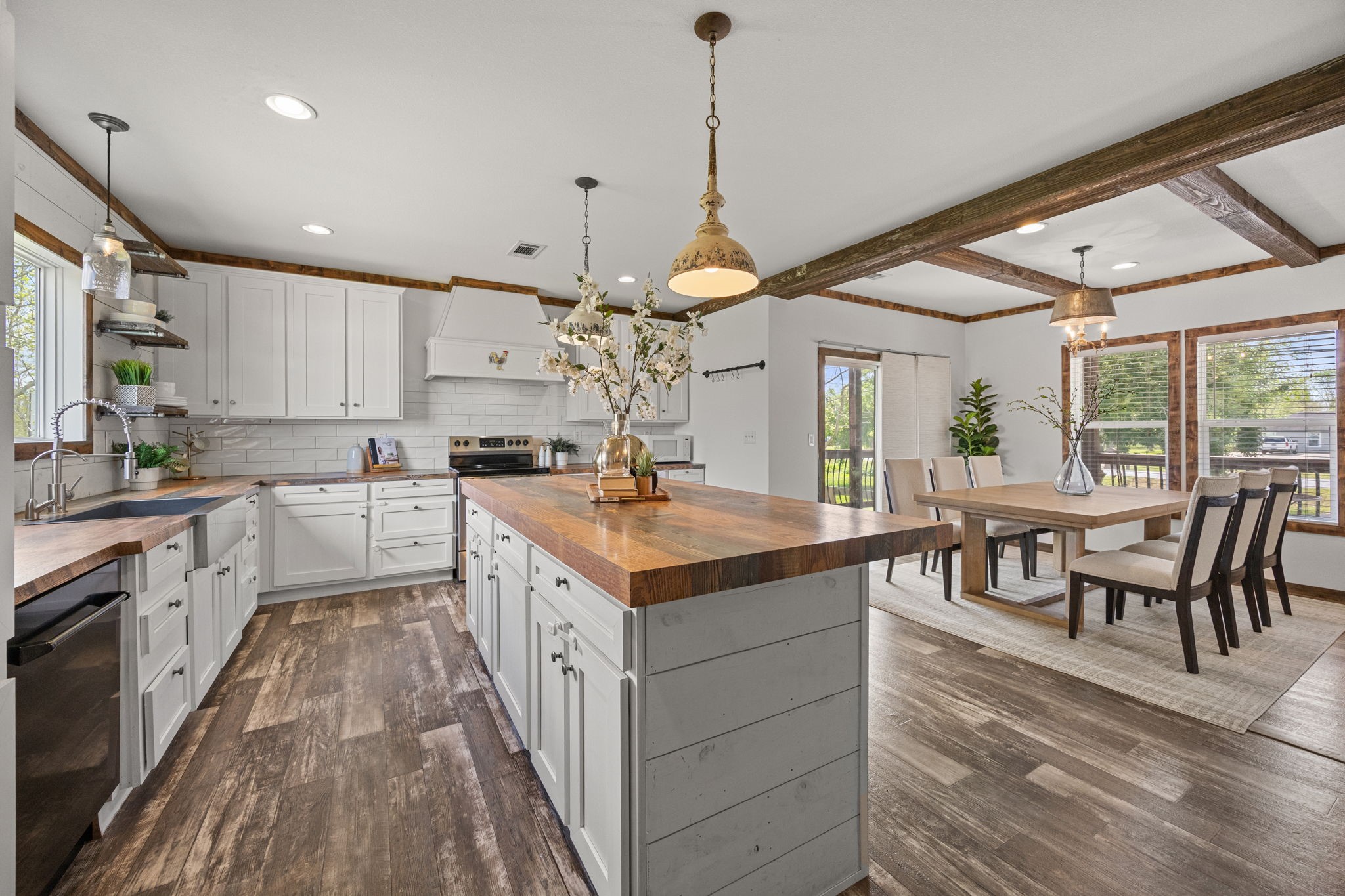 12708 28th Street Santa Fe, TX 77510 - Photo 9 of 29 a kitchen with kitchen island granite countertop a sink a counter space appliances and a living room view