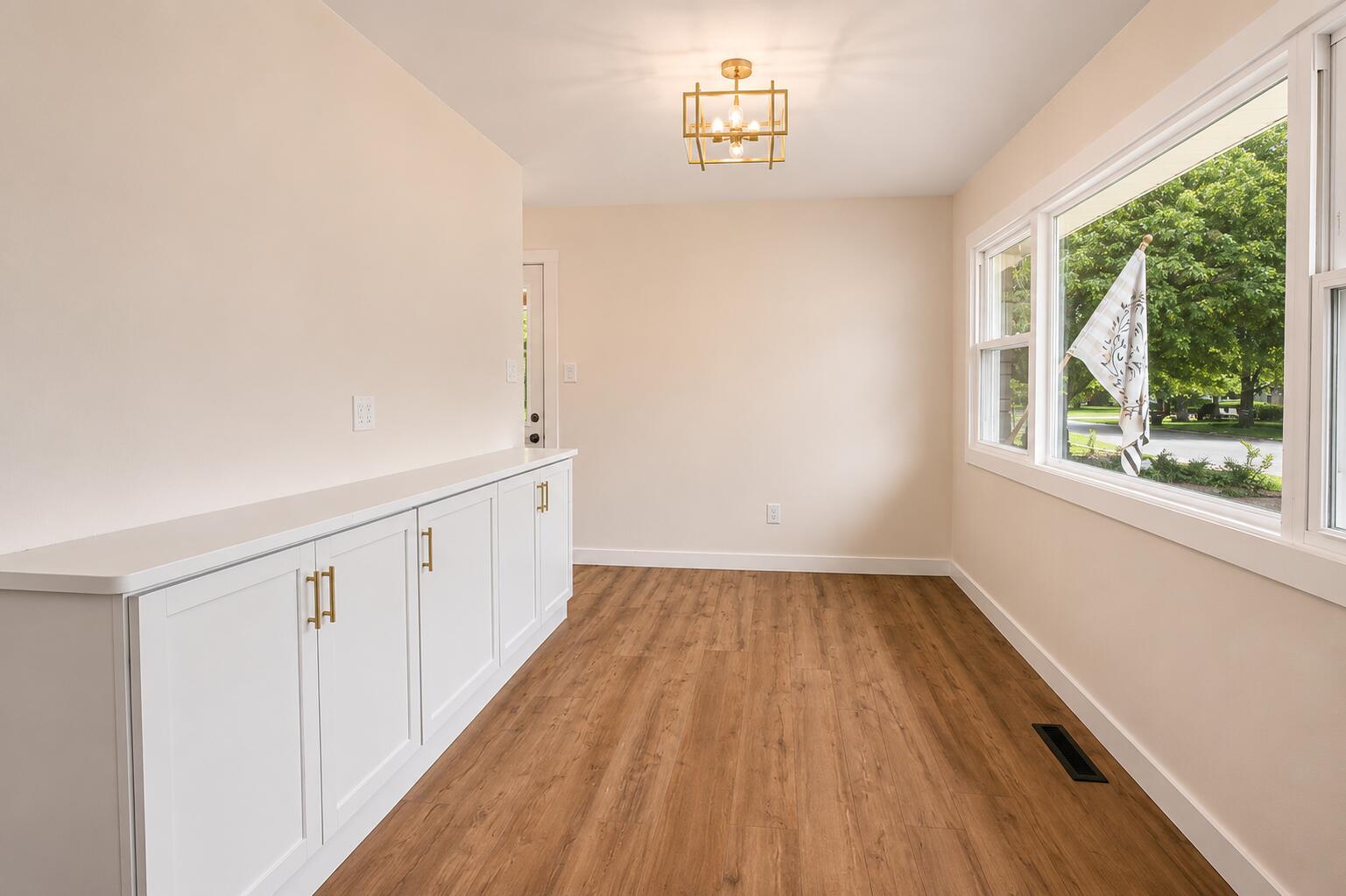 414 Holly Road Michigan City, IN 46360 - Photo 16 of 41 a view of an empty room with wooden floor and a window