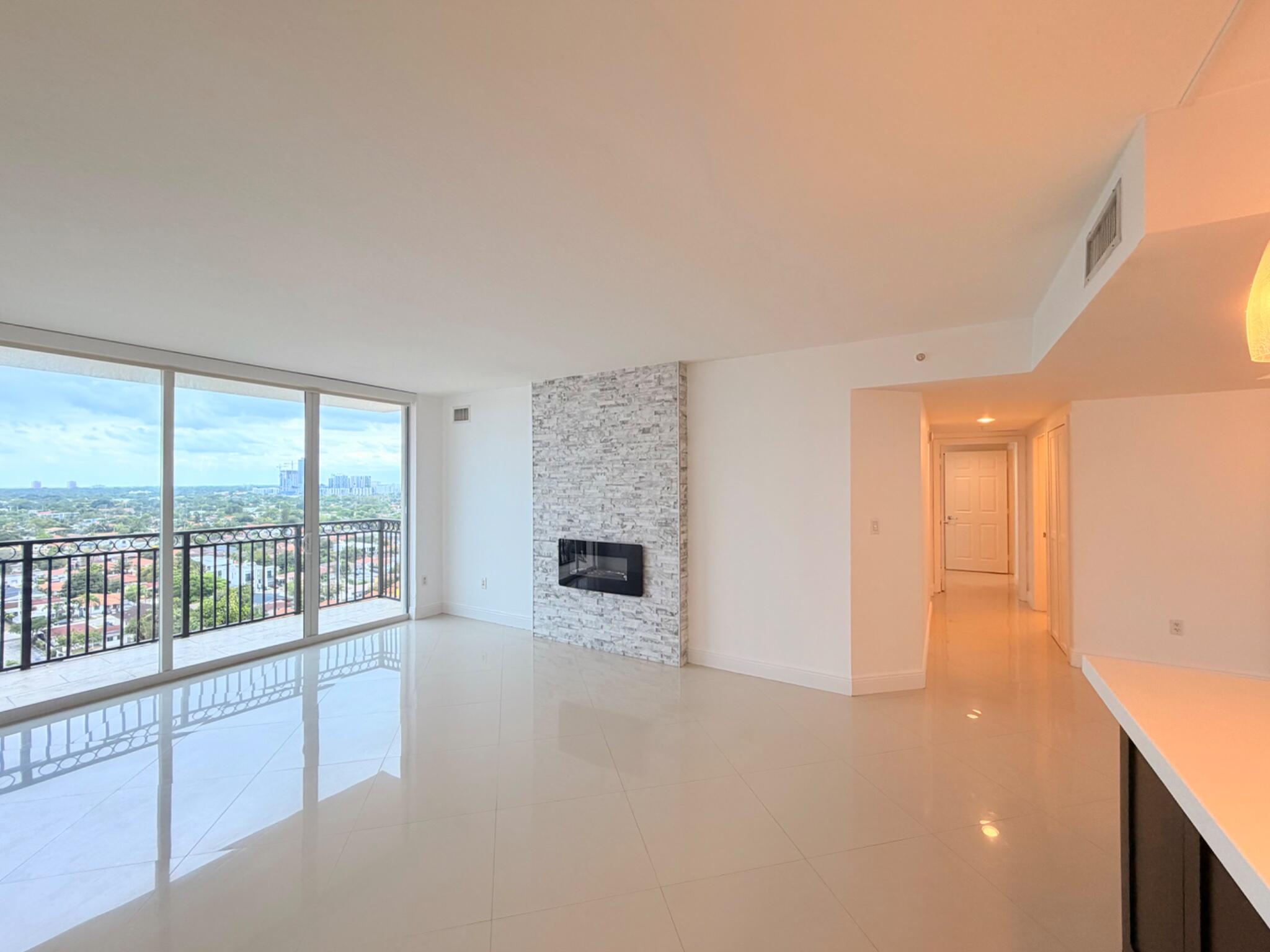 3232 Coral Way, Unit 1601 Miami, FL 33145 - Photo 13 of 27 an empty room with fireplace and windows