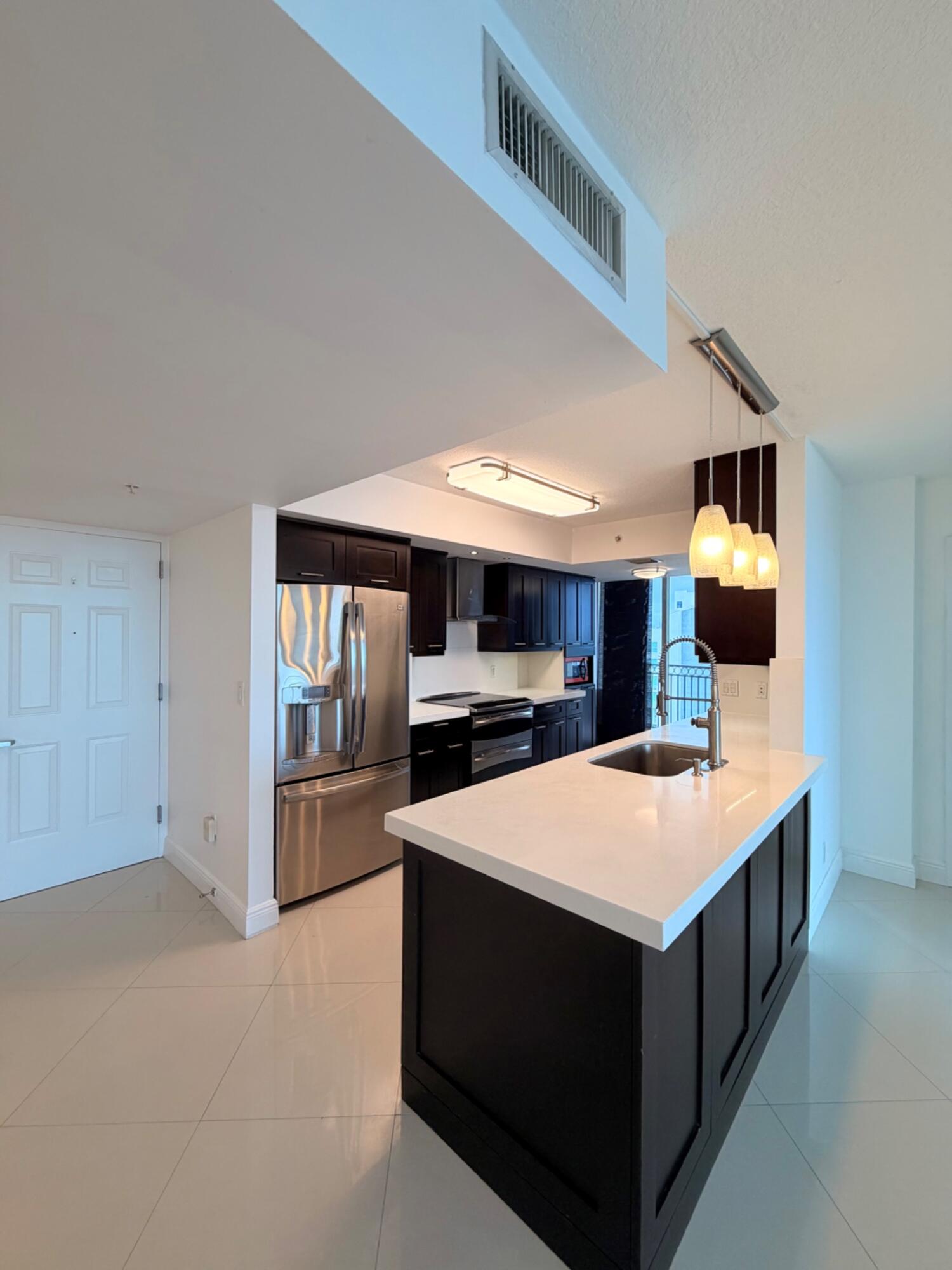 3232 Coral Way, Unit 1601 Miami, FL 33145 - Photo 16 of 27 a large kitchen with a stove and a sink