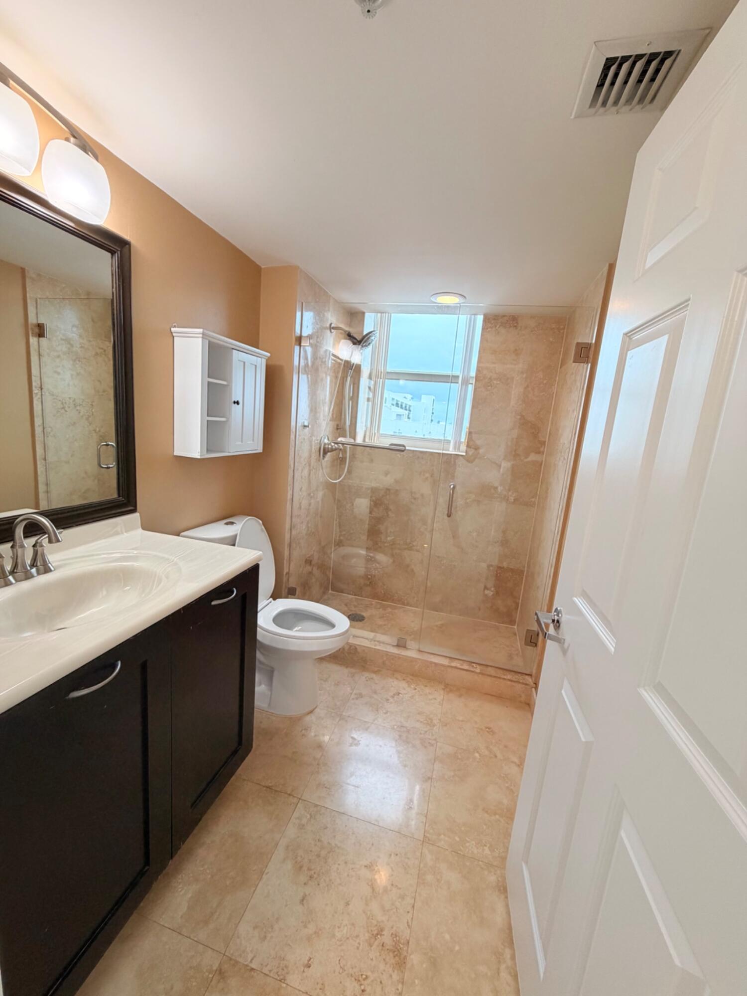 3232 Coral Way, Unit 1601 Miami, FL 33145 - Photo 18 of 27 a bathroom with a sink a toilet and shower