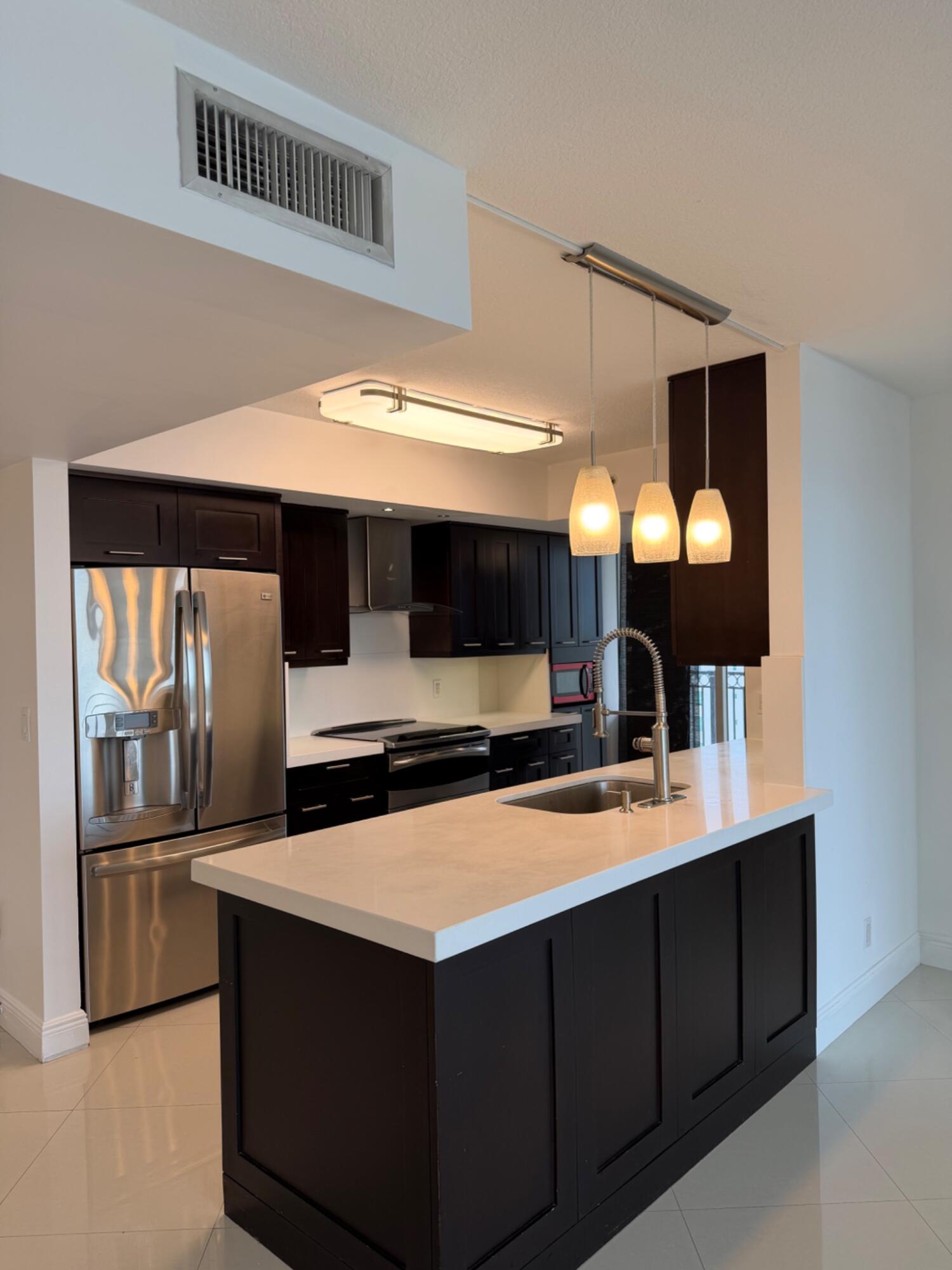 3232 Coral Way, Unit 1601 Miami, FL 33145 - Photo 2 of 27 a kitchen with stainless steel appliances a sink and a refrigerator