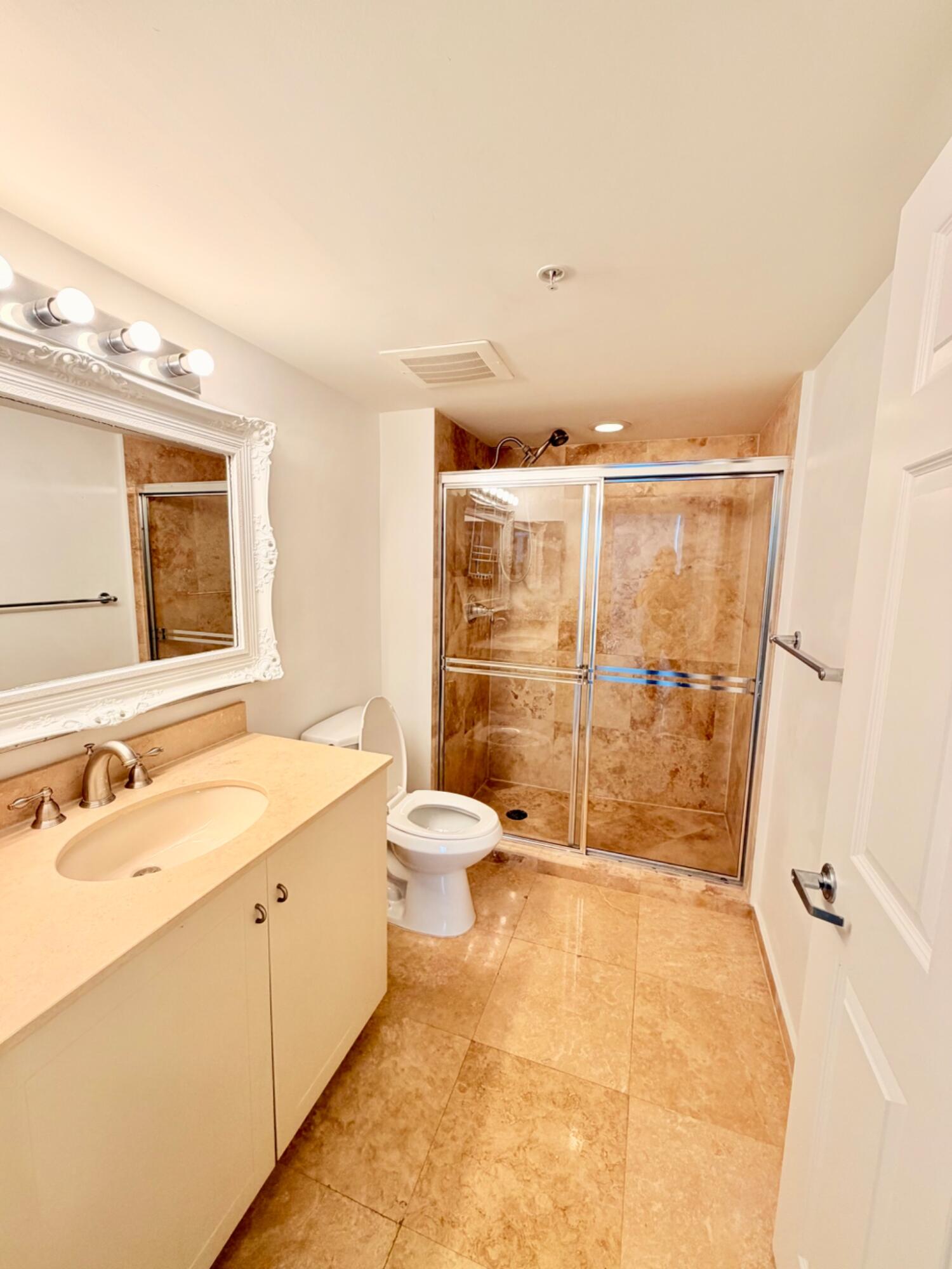 3232 Coral Way, Unit 1601 Miami, FL 33145 - Photo 24 of 27 a bathroom with a granite countertop sink a toilet a mirror and shower