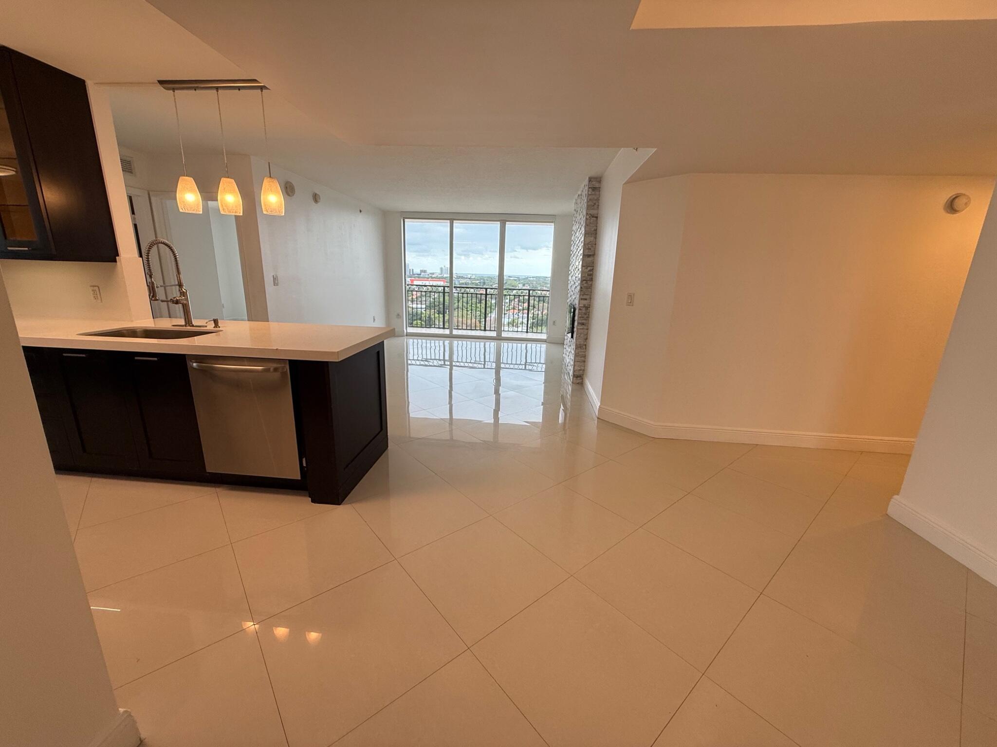 3232 Coral Way, Unit 1601 Miami, FL 33145 - Photo 10 of 27 a view of a kitchen with a sink and a refrigerator