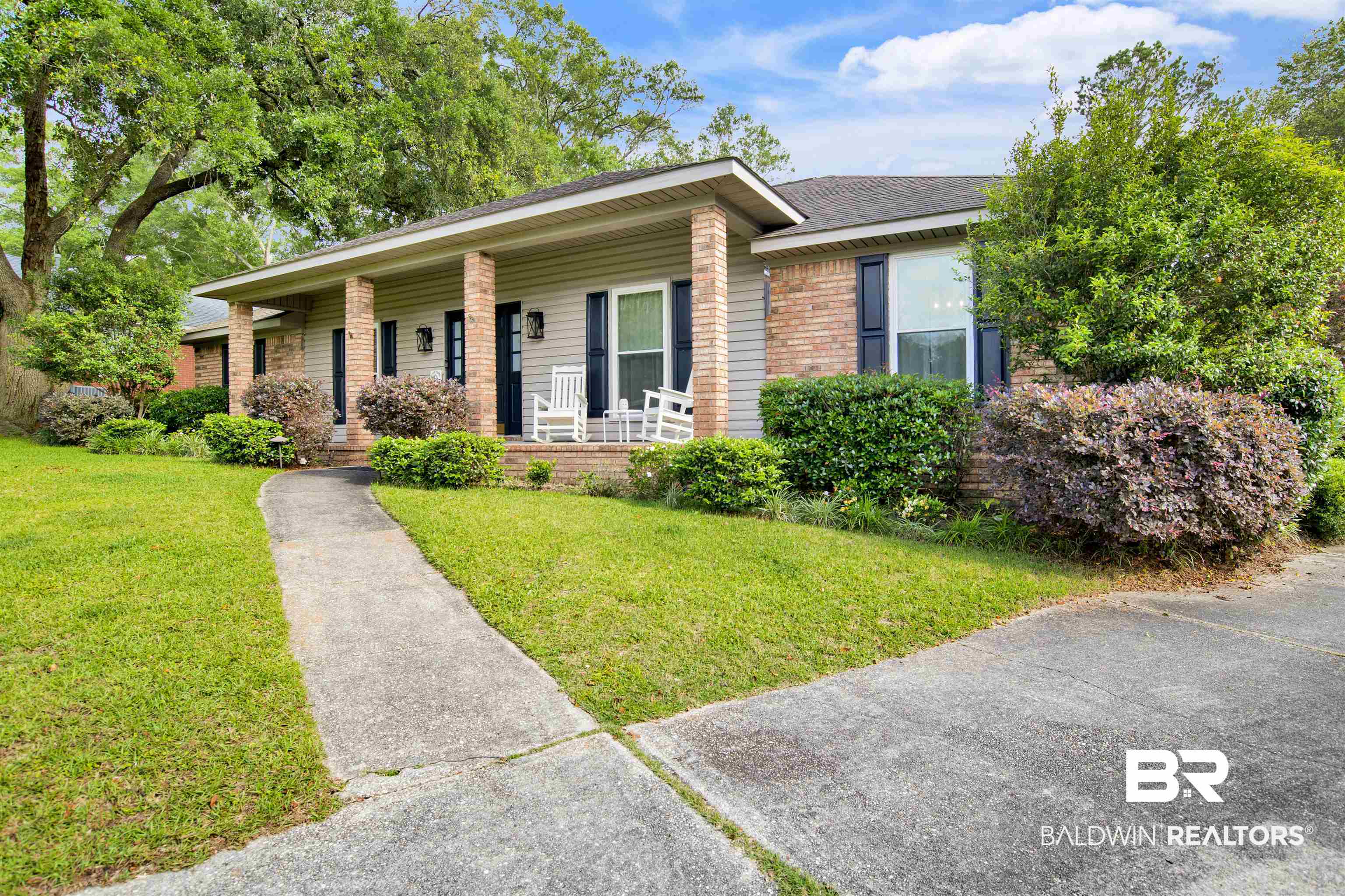 7431 Summer Court Mobile, AL 36695 - Photo 3 of 37 Ranch-style house featuring a porch, a front lawn, brick siding, and a shingled roof