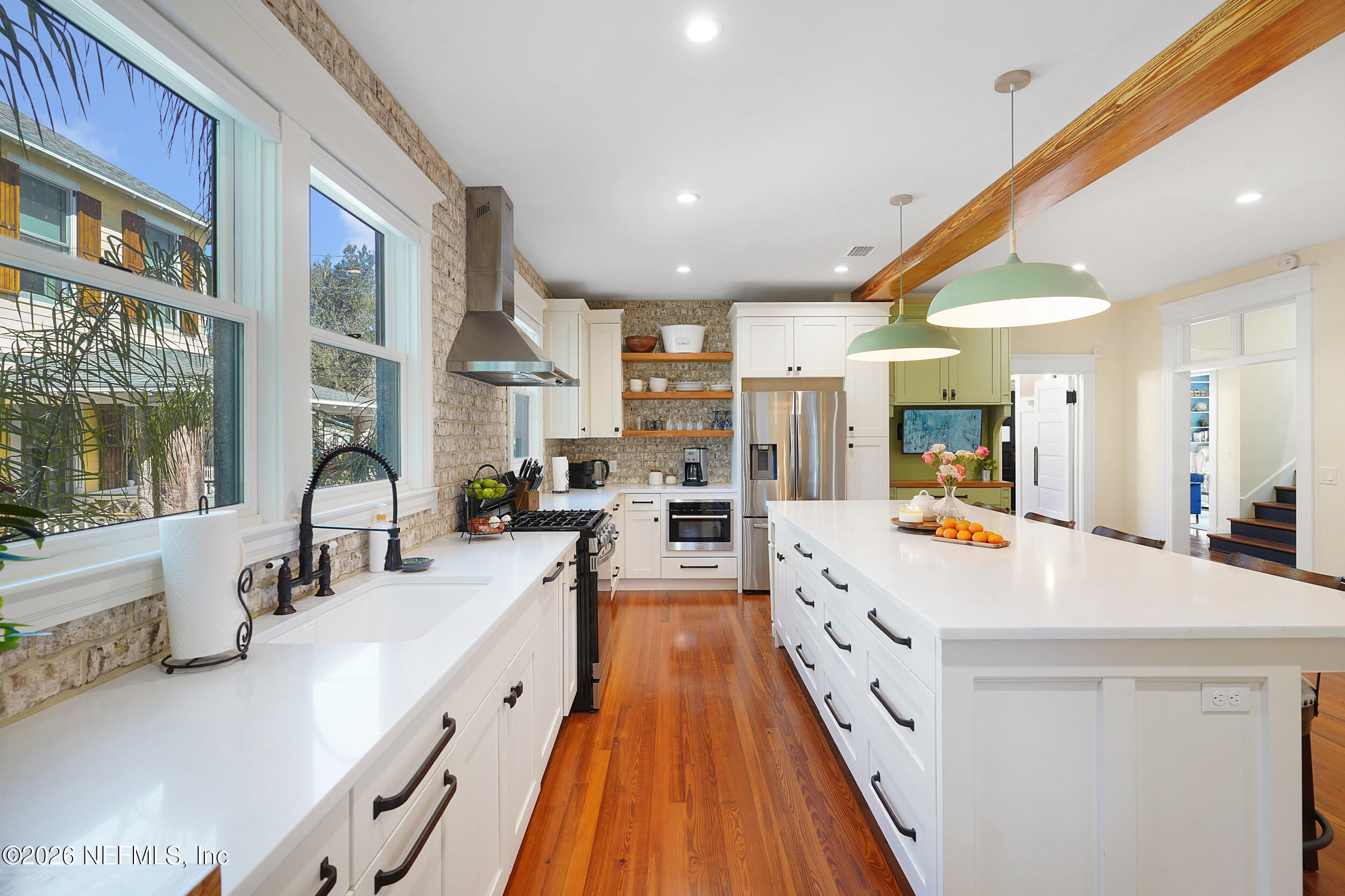 290 St George Street, Unit A St. Augustine, FL 32084 - Photo 11 of 32 a large kitchen with stainless steel appliances a lot of counter space and a large window