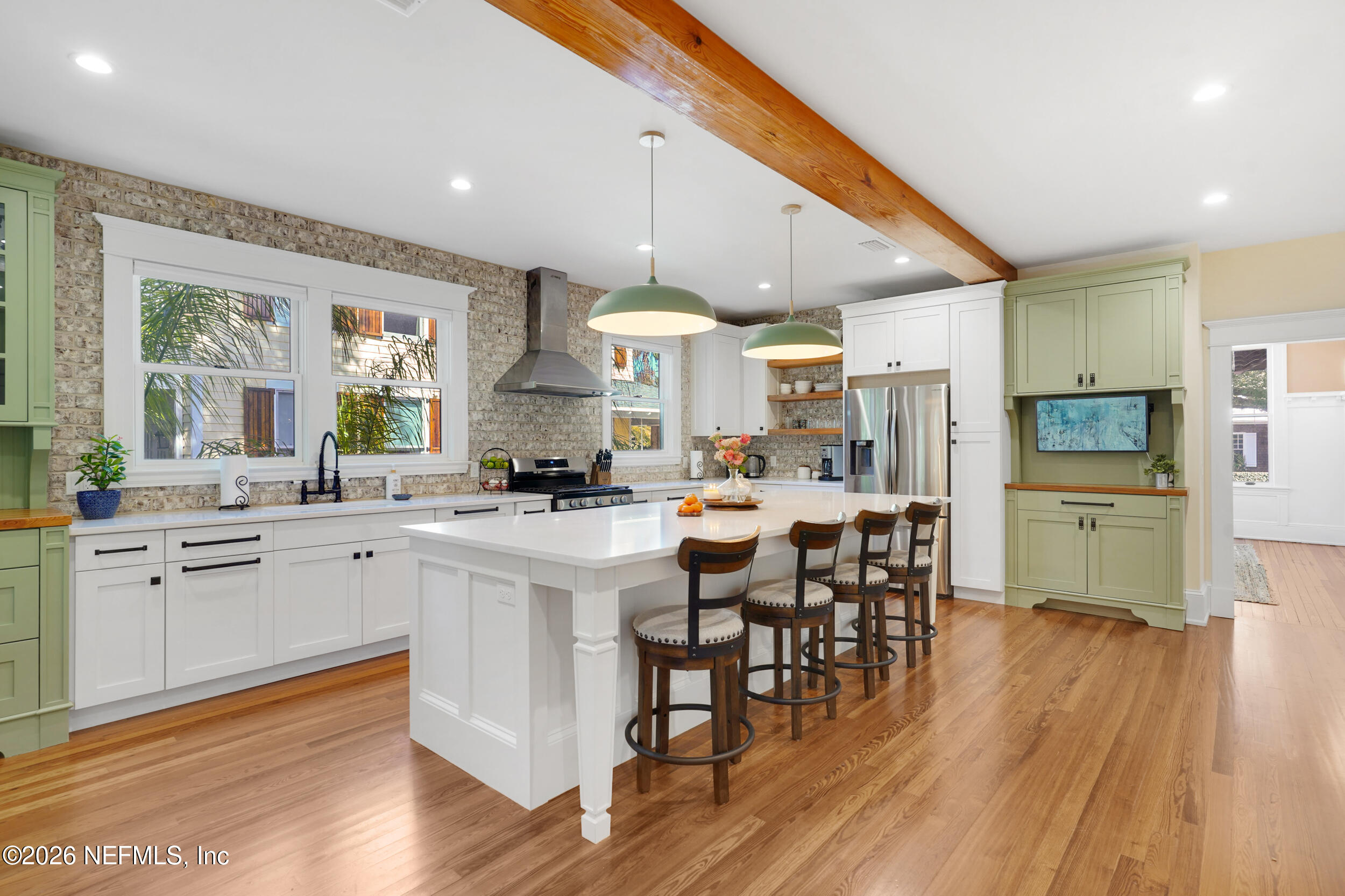 290 St George Street, Unit A St. Augustine, FL 32084 - Photo 14 of 32 a kitchen with stainless steel appliances kitchen island granite countertop a table chairs sink and cabinets