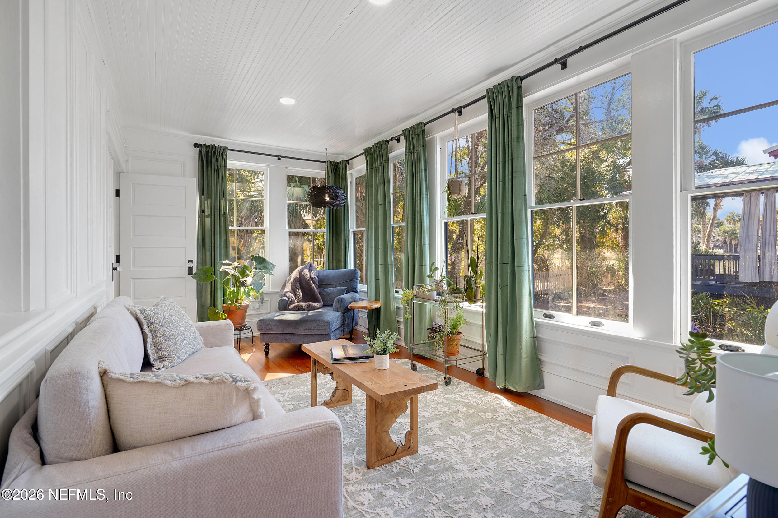 290 St George Street, Unit A St. Augustine, FL 32084 - Photo 18 of 32 a living room with furniture and floor to ceiling windows