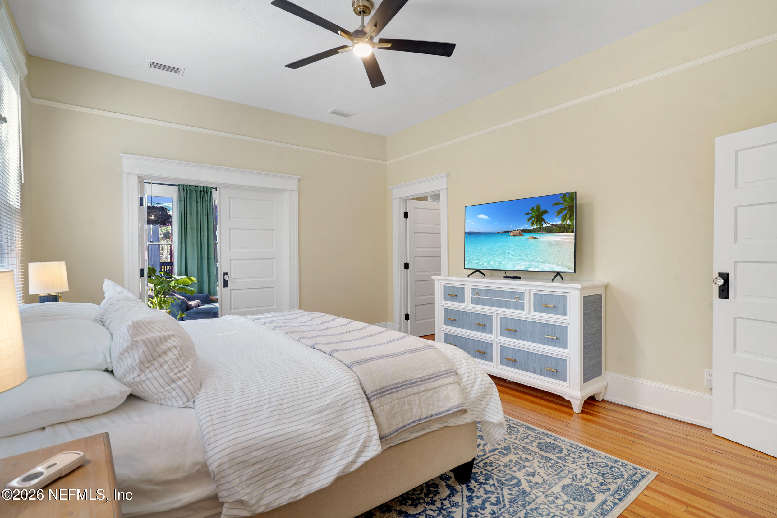 290 St George Street, Unit A St. Augustine, FL 32084 - Photo 20 of 32 a bedroom with a bed and a flat screen tv