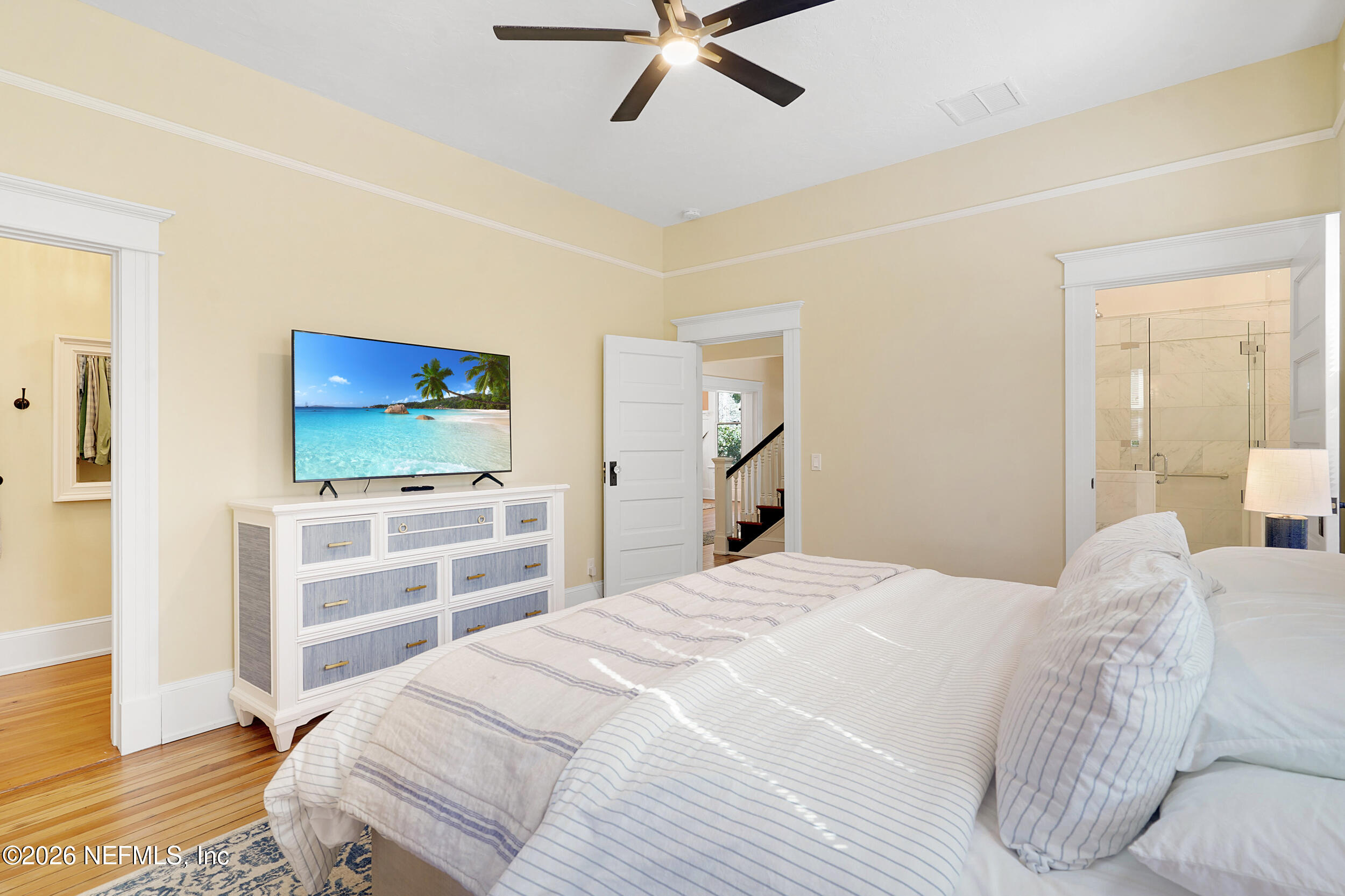 290 St George Street, Unit A St. Augustine, FL 32084 - Photo 21 of 32 a bedroom with a bed and a flat screen tv