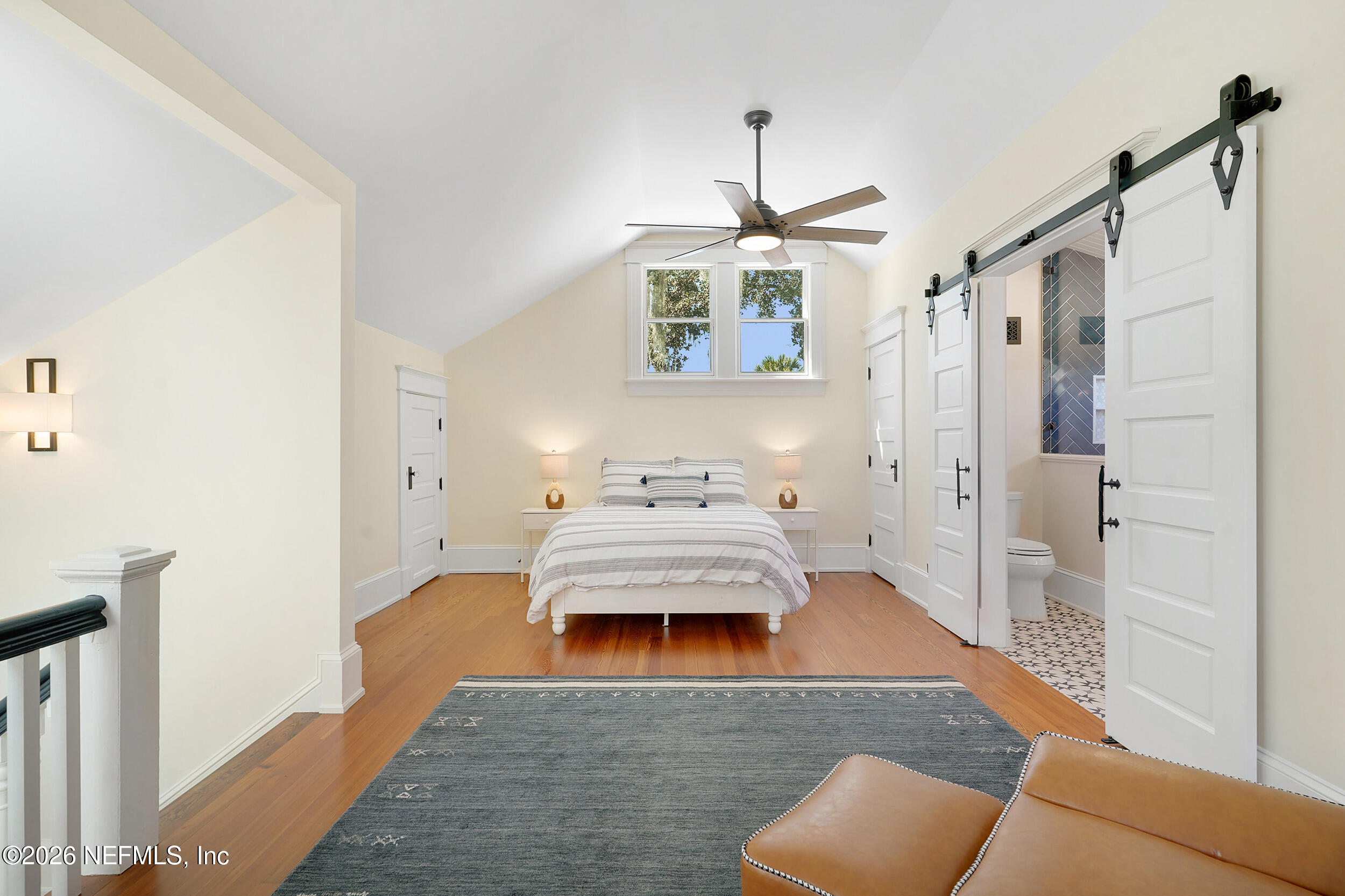 290 St George Street, Unit A St. Augustine, FL 32084 - Photo 27 of 32 a bedroom with a bed and a couch