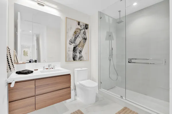 walk in closet with lots of frames on wall