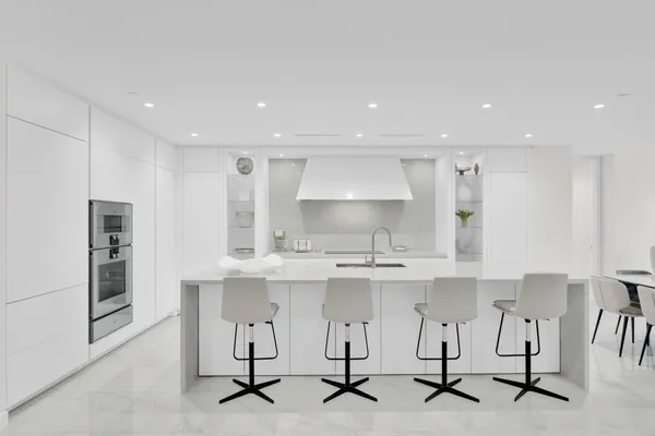 a bathroom with a bathtub a double vanity sink and mirror