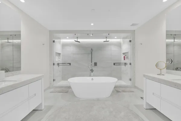 a spacious bedroom with a bed and glass window