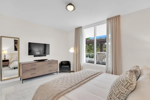 a bedroom with a bed and a flat screen tv