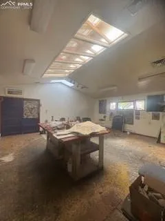 an empty room with a window and a ceiling fan