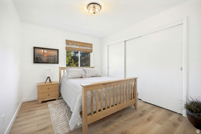 1723 Albury Road Sandy, UT 84092 - Photo 15 of 23 Interior room featuring light wood-finish flooring, white walls, and a window with a woven shade