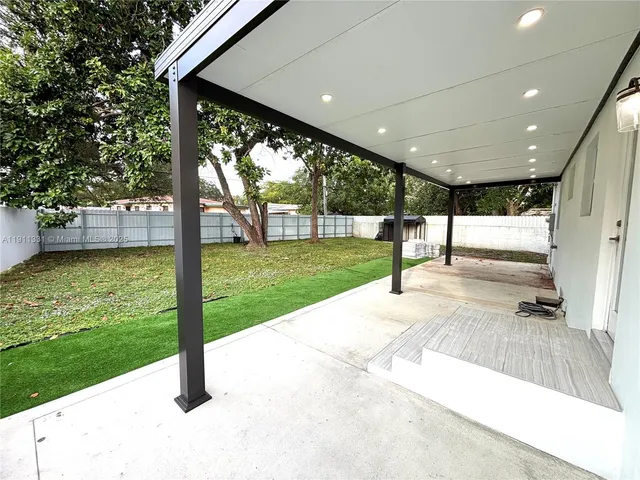 a kitchen with kitchen island a counter top space cabinets and stainless steel appliances
