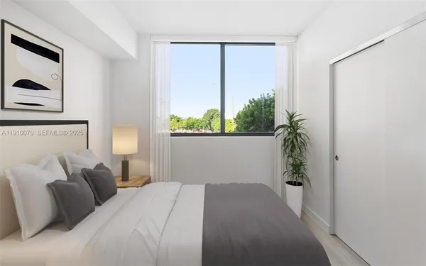 a bedroom with a bed and a window