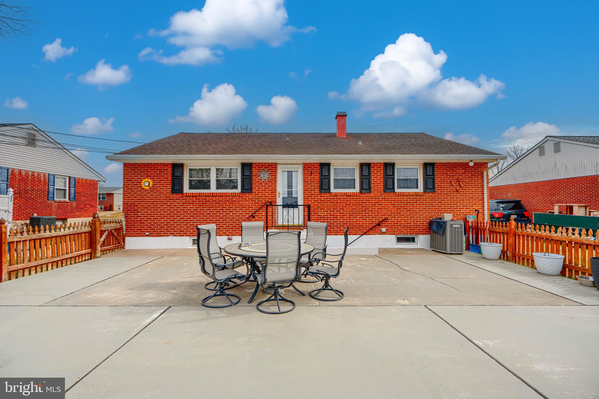 9518 Holiday Manor Road Baltimore, MD 21236 - Photo 6 of 8 a view of a patio with table and chairs a barbeque with wooden floor