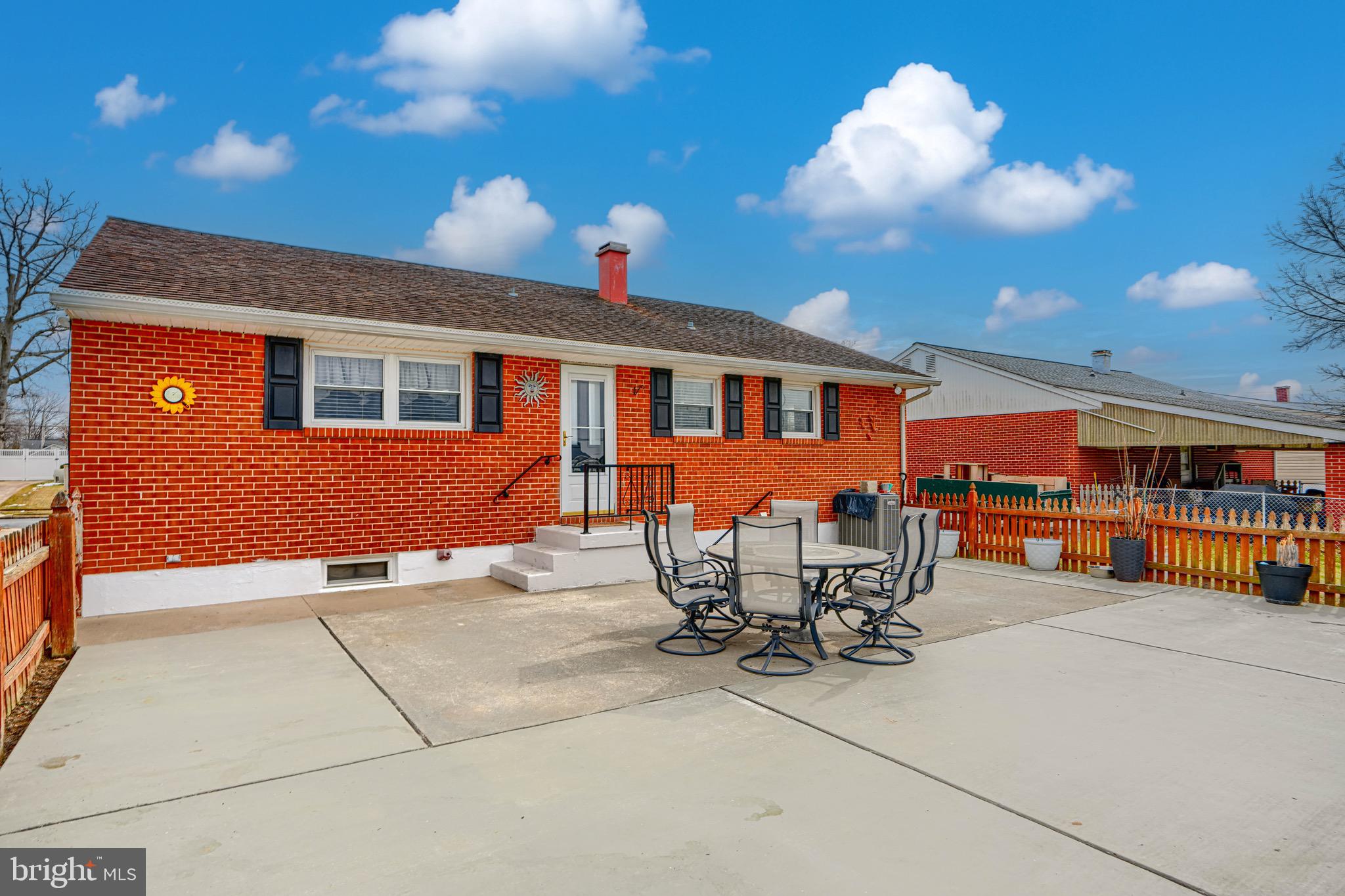 9518 Holiday Manor Road Baltimore, MD 21236 - Photo 7 of 8 a view of a patio with table and chairs and potted plants