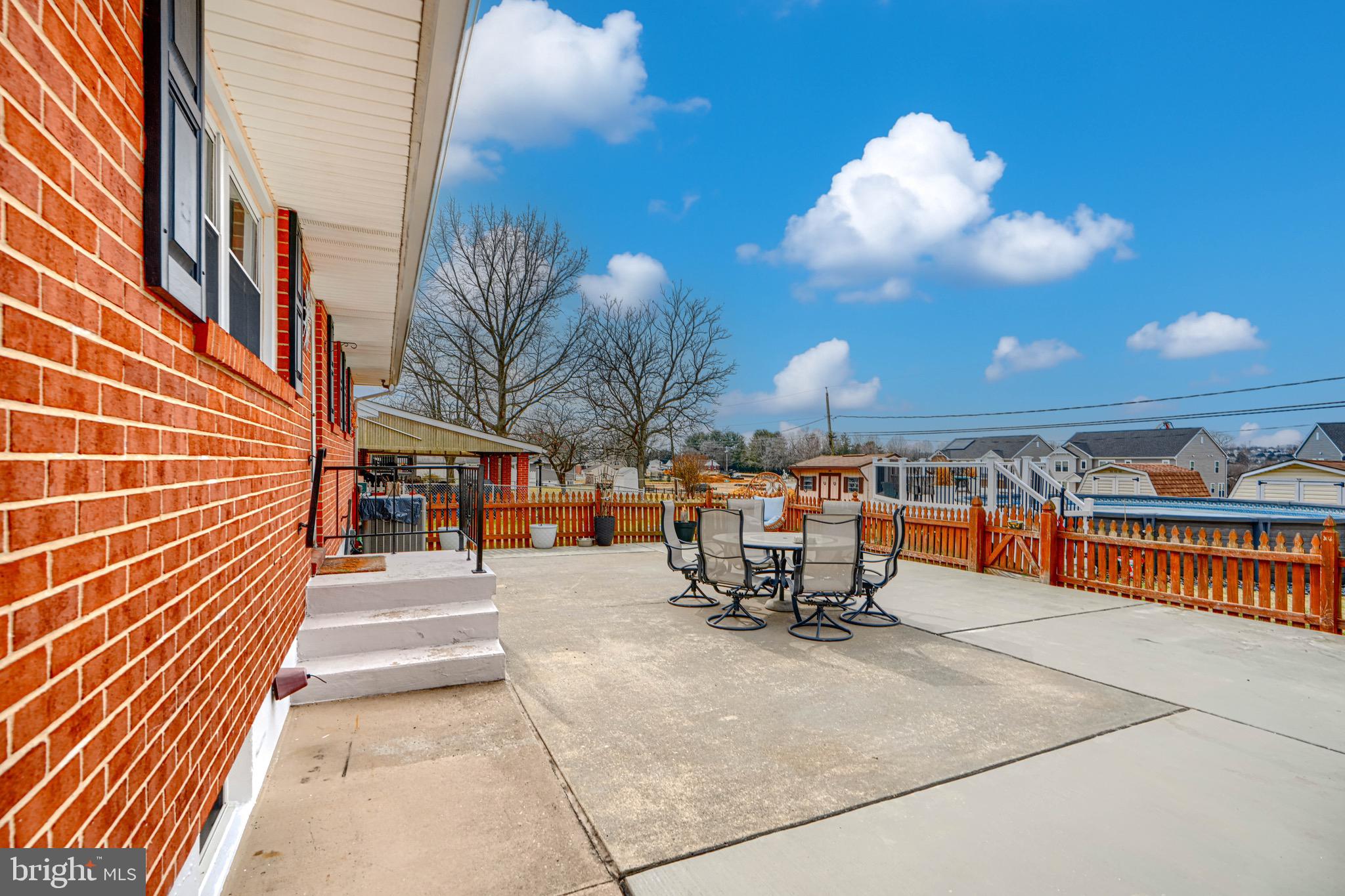 9518 Holiday Manor Road Baltimore, MD 21236 - Photo 8 of 8 a view of a patio with a table and chairs