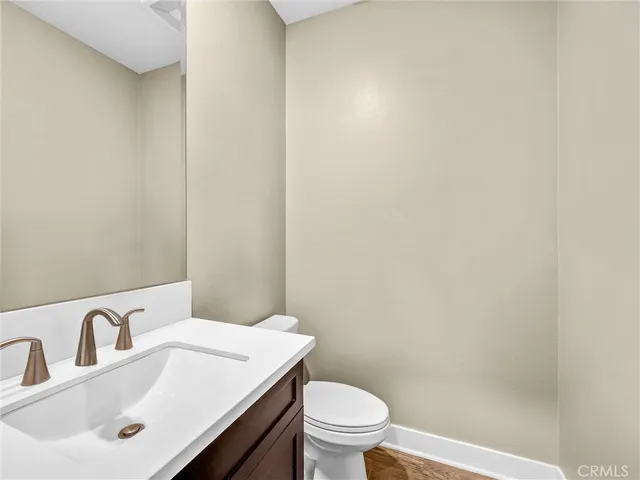 a bathroom with a sink a toilet and mirror