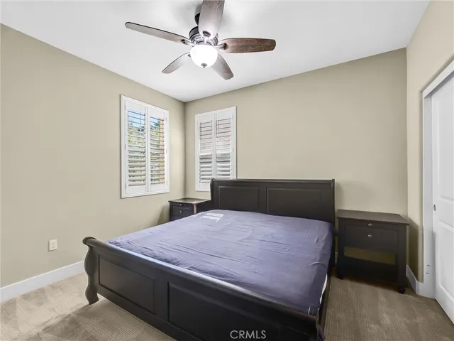 a bed sitting in a bedroom next to a window