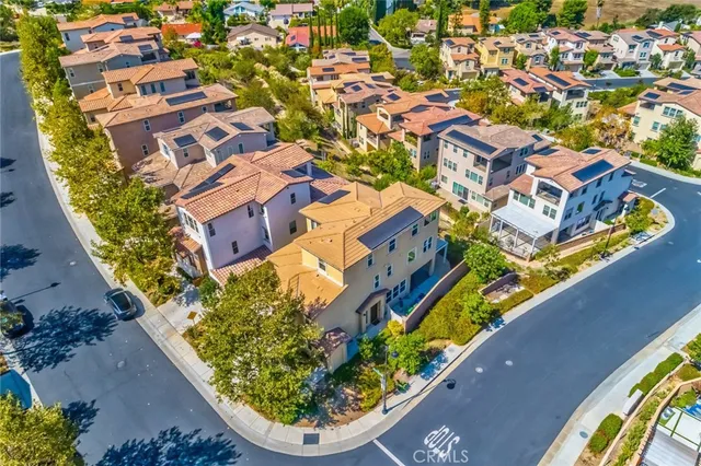 an aerial view of a house with a garden and lake view