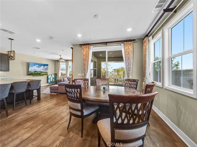 a dining room with furniture window and wooden floor