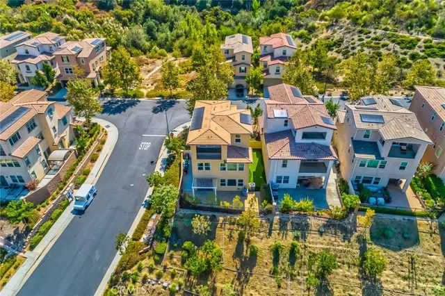 an aerial view of residential houses with outdoor space
