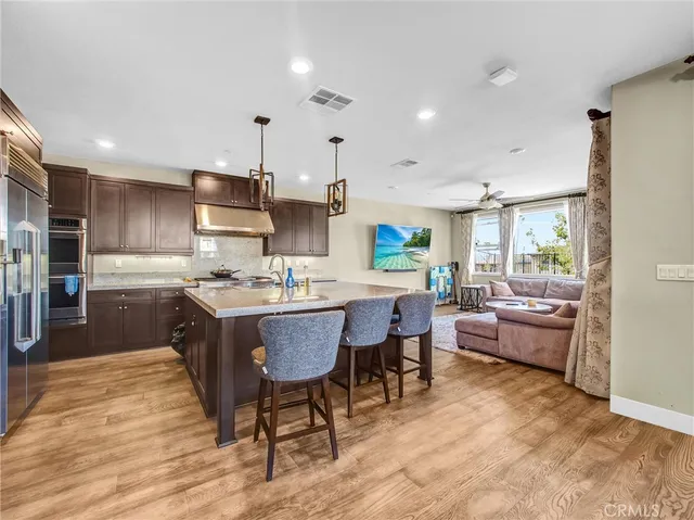 a kitchen with a sink a counter top space and stainless steel appliances