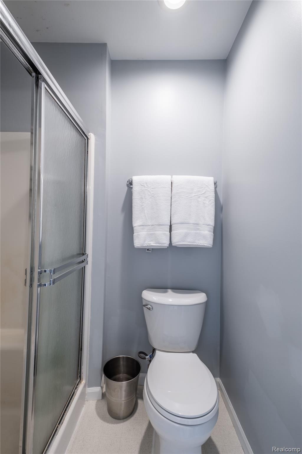 3483 Lahring Road Linden, MI 48451 - Photo 8 of 34 Bathroom featuring a shower with a sliding glass door, a toilet, a chrome towel bar, and recessed ceiling lighting