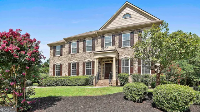 a front view of a house with a yard