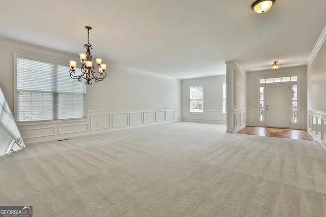 a large kitchen with stainless steel appliances granite countertop a stove top oven a sink a counter space and cabinets