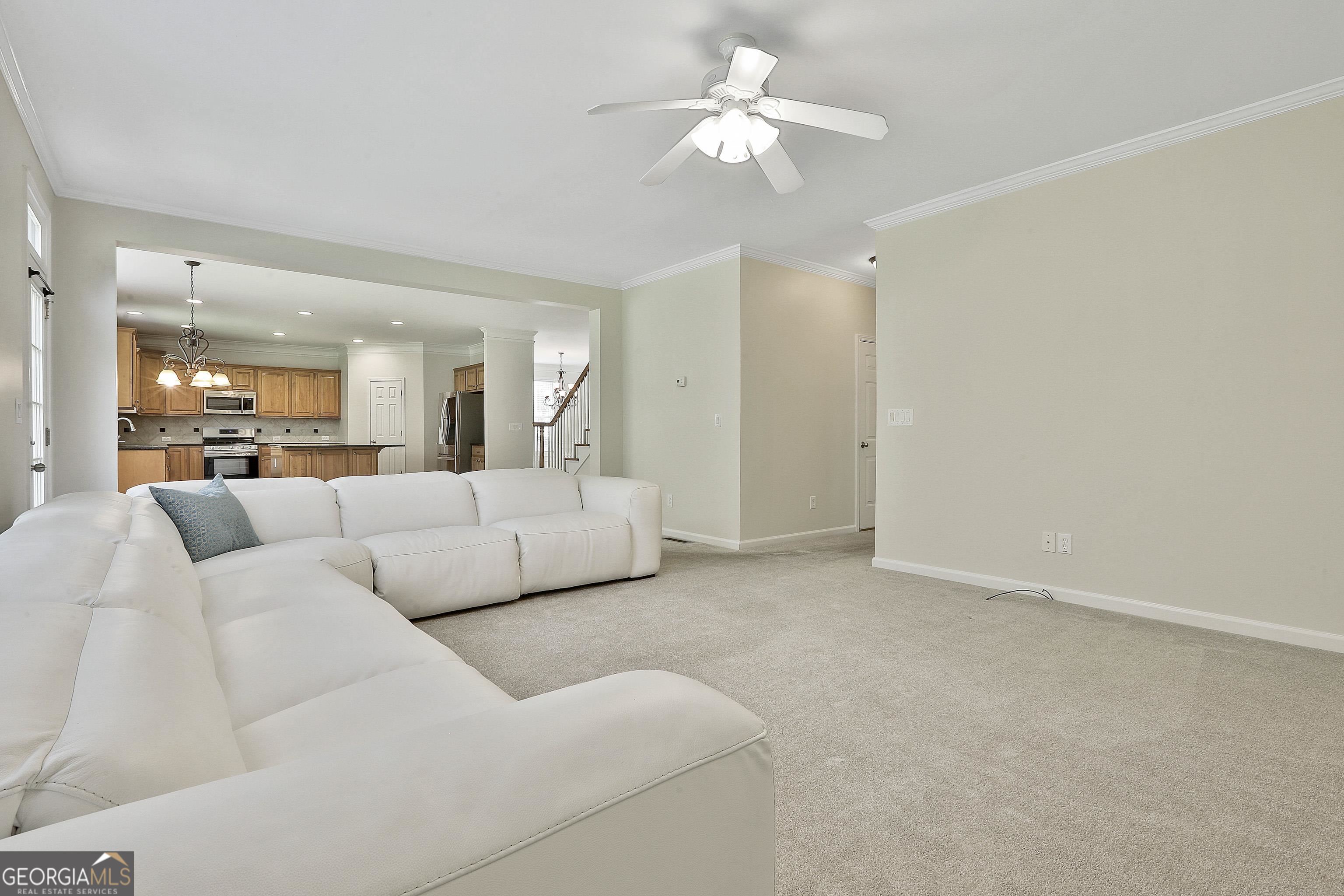 113 Westmont Way Tyrone, GA 30290 - Photo 29 of 64 a living room with furniture and a chandelier
