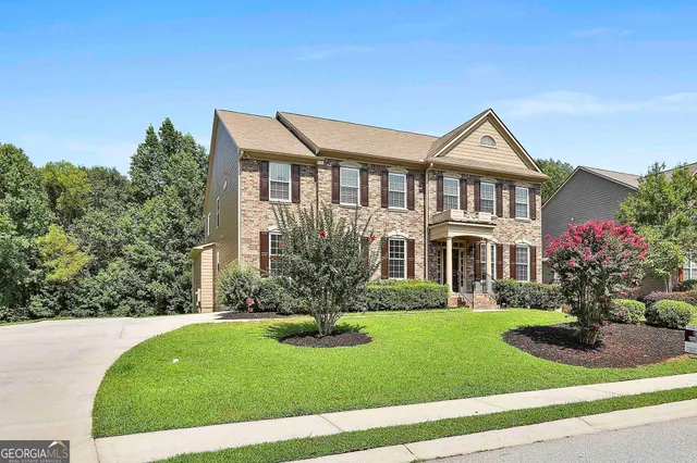 a front view of a house with a yard