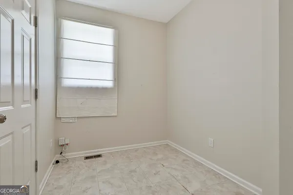 an empty room with windows and closet
