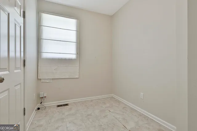 an empty room with windows and closet