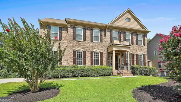 a front view of a house with a yard