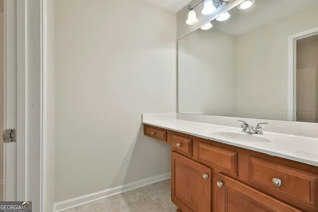 a front view of a house with a garden and lake view