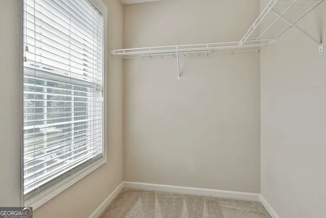 a view of a house with a yard and a large tree