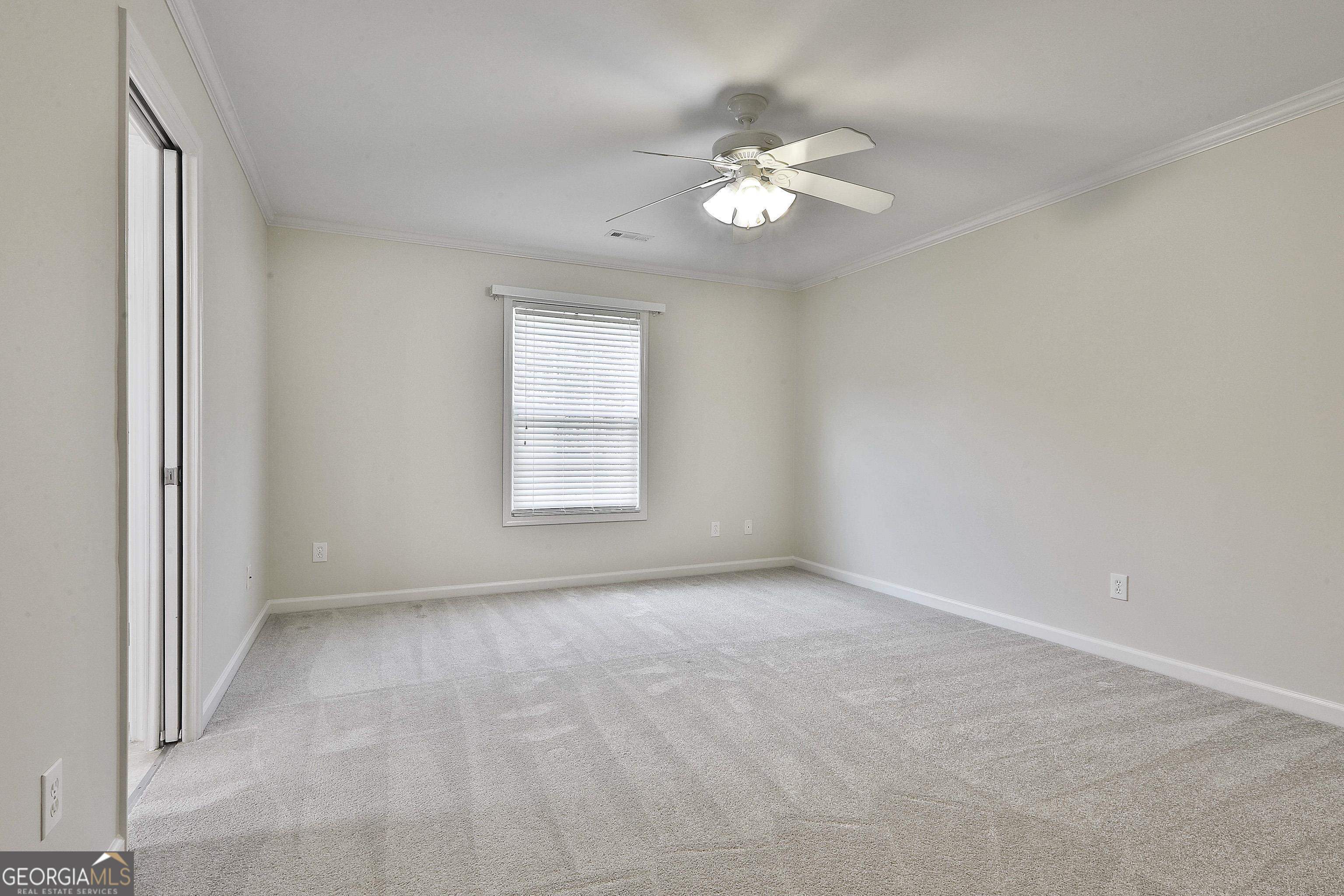 113 Westmont Way Tyrone, GA 30290 - Photo 50 of 64 an empty room with windows and chandelier fan